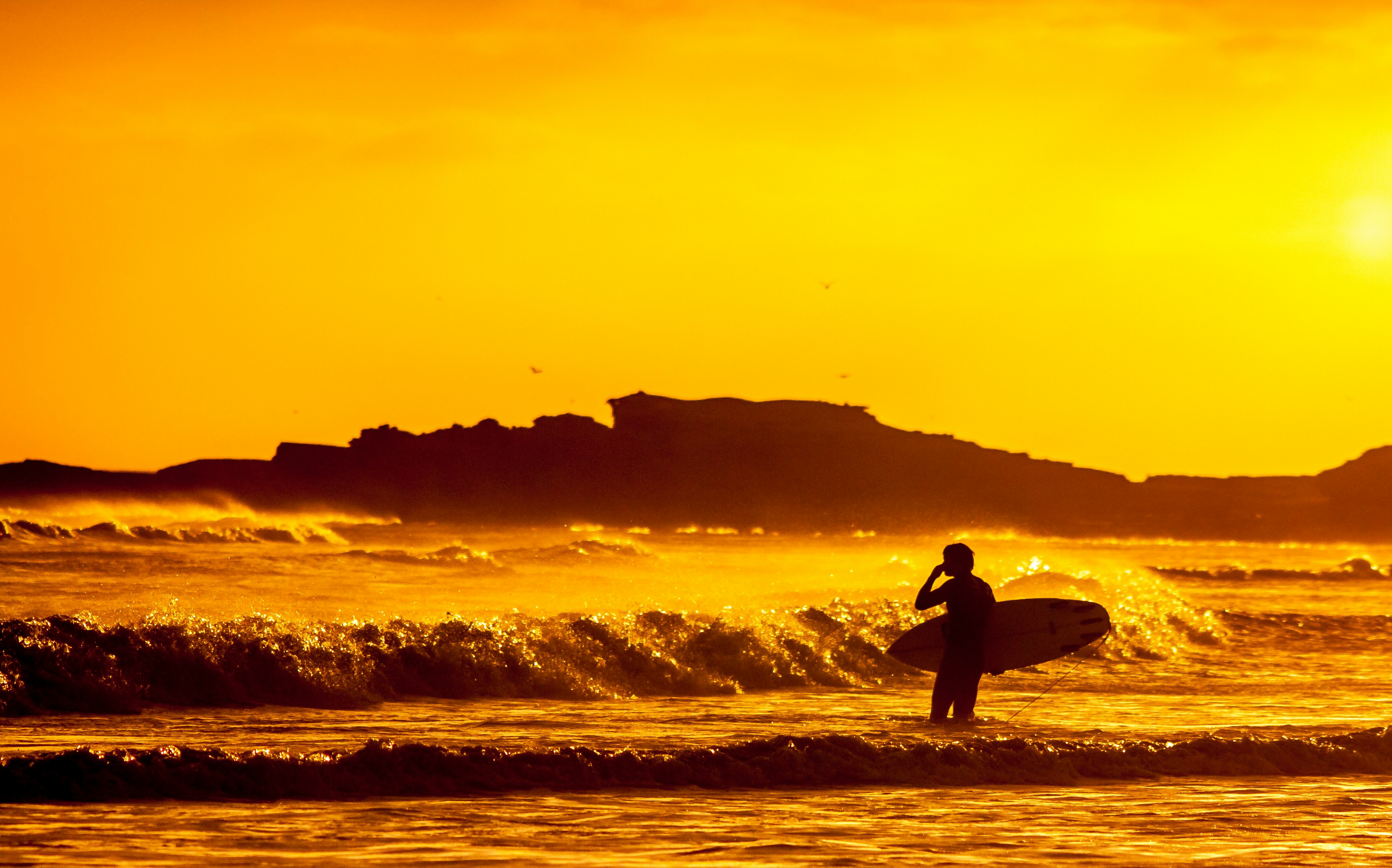 man holding white surfboard